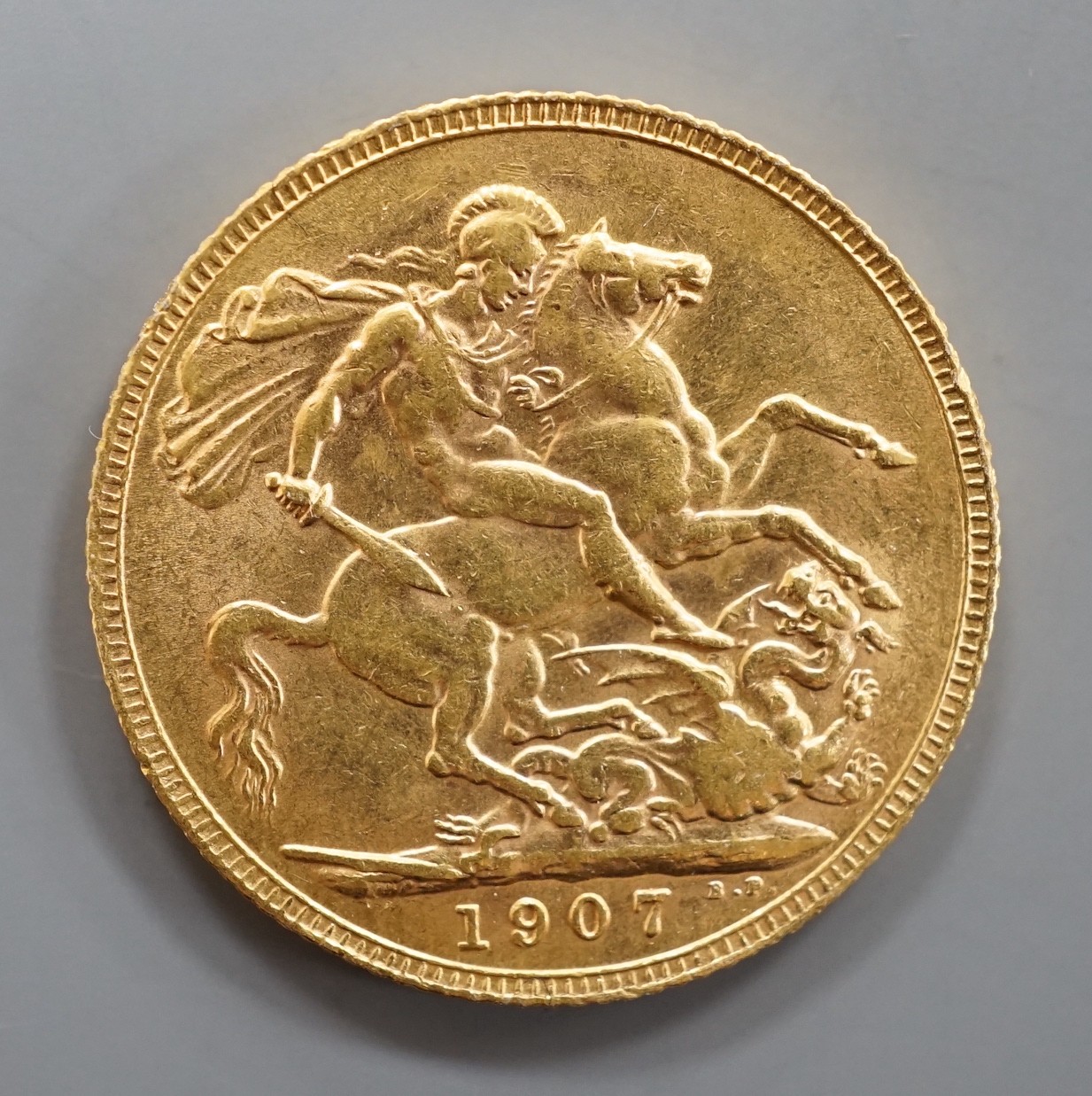 An Edward VII 1907 gold sovereign.